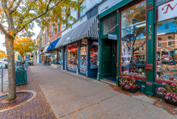 A clean street in fall with small shops